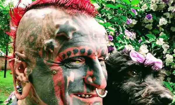 man pierced scrotum and tattoo into his skull