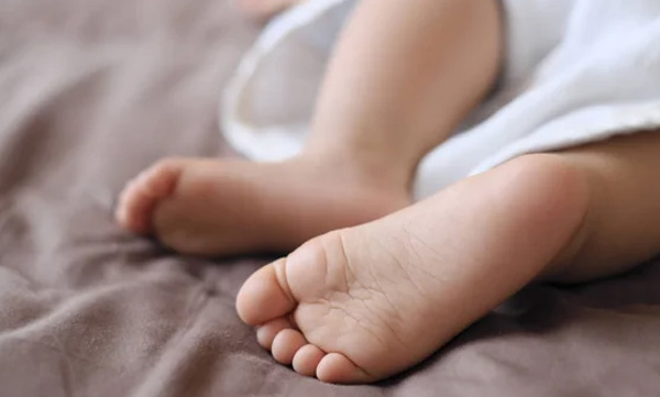 Child of tribal woman who gave birth in forest dies