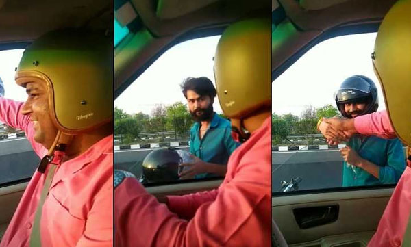 Raghavendra Kumar came to the car and presented the helmet to the young man who was traveling without a helmet