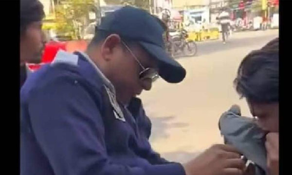 The policeman saved the pigeon whose neck was entangled by the string of the kite