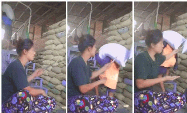This is the 'Quality Inspector': a young woman who pokes into a sack and checks the quality of rice in seconds