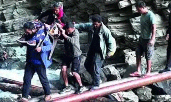 woman in labour carried on chair to health centre 30km away