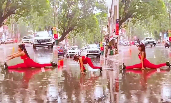 Young woman practices yoga in the middle of the rain; A traffic jam followed; Police by paying the fine