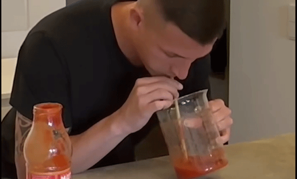 Young man holds the world record by drinking tomato sauce
