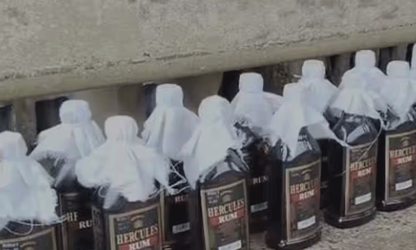 Bag left near washroom of general compartment; During the inspection, 18 bottles of liquor were found