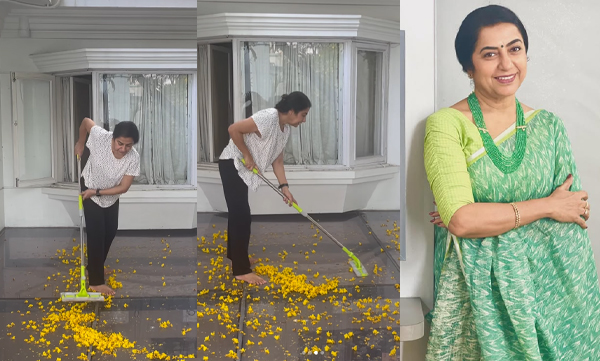 Suhasini wipes away yellow flowers that have fallen from the glass roof top of her house