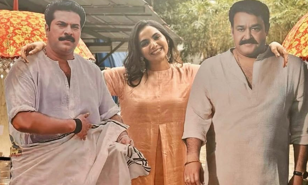 samvrutha-sunil-poses-proudly-between-mohanlal-and-mammoottys-flex
