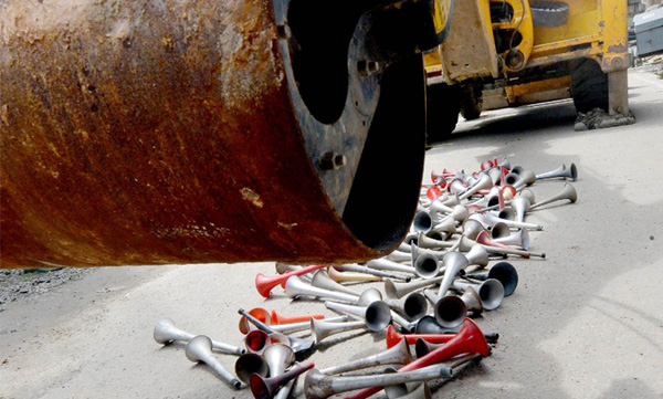 Strict action: Seized air horns were crushed by road rollers