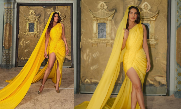 Priyanka Chopra wore a saffron-hued saree gown in an asymmetrical style with a draped bodice