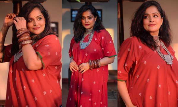 Ramya Nambeesan looks sharp in a red printed kurti, wooden bangles and oxidized necklaces